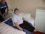 Patient sits onto bed 